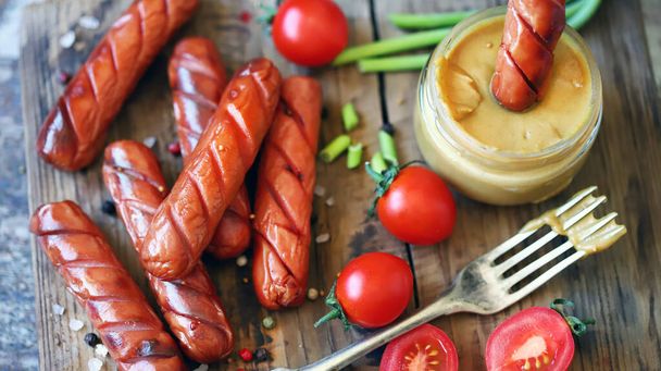 Appetizing fried sausages with mustard. German sausages. Snack for beer. - Photo, Image