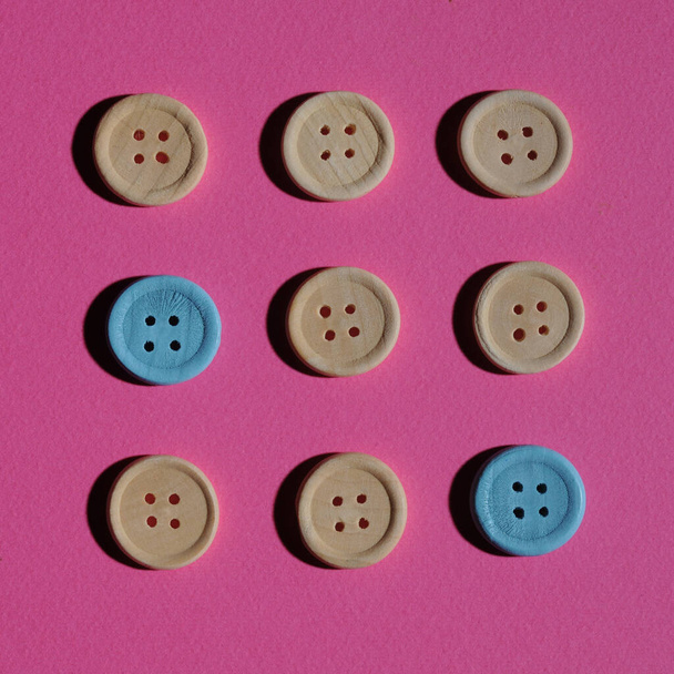 The concept of wooden buttons on a pink background ... - Foto, afbeelding