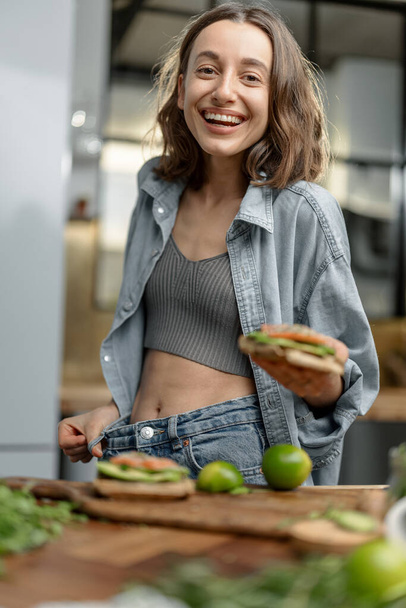 Happy slim woman showing her weight loss - Fotó, kép
