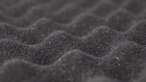 Cushioning porous foam protective material. Abstract wavy bumpy dark dusty abstract background. Macro shot. Rotation - Footage, Video