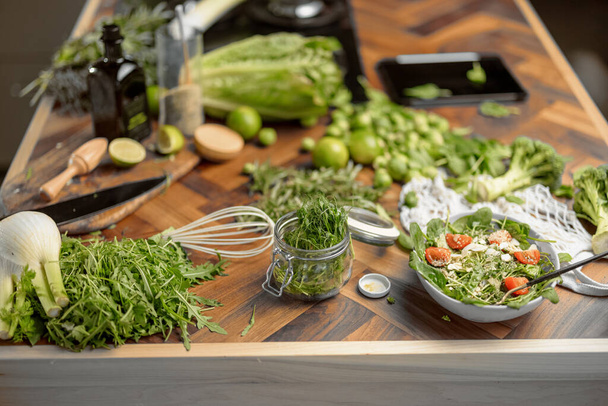 Healthy food on kitchen with woman on background - Valokuva, kuva