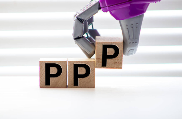 Pile with three wooden cubes - letters PPP meaning Praise Picture Push on them, space for more text, images at right side. - Photo, Image