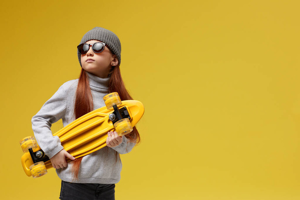 little child girl with yellow skateboard - Photo, Image