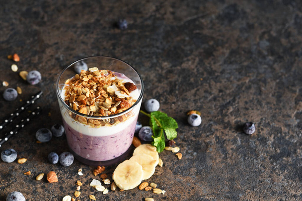 Smoothies with blueberries and granola on a concrete background. Detox menu. Diet. - Fotó, kép