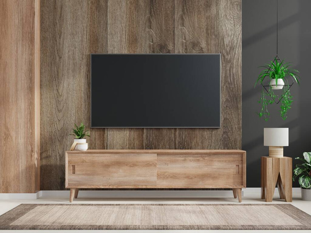 Mockup έναν τοίχο τηλεόραση τοποθετείται σε ένα σκοτεινό δωμάτιο με σκούρο τοίχο ξύλου.3d απόδοση - Φωτογραφία, εικόνα