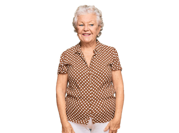 Senior grey-haired woman wearing casual clothes looking positive and happy standing and smiling with a confident smile showing teeth  - Foto, afbeelding