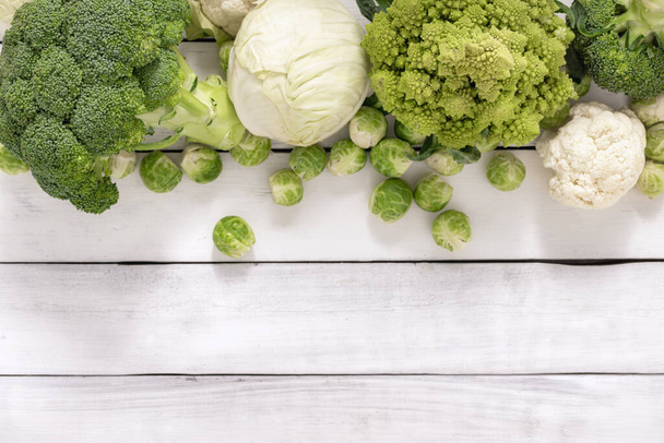 Banner assorted cabbage on boards in center. Brussels sprouts, white cabbage, cauliflower, broccoli. Top view - Foto, imagen