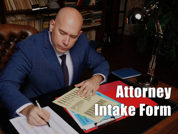 Business concept about Attorney Intake Form Mężczyzna pracownik biurowy w żółtej koszuli trzymając i pisząc dokumenty na office des - Zdjęcie, obraz