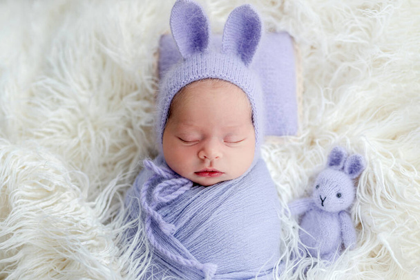 Cute newborn wearing hat with hare ears - 写真・画像
