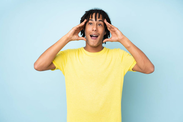 Young african american man isolated on blue background with surprise expression - Foto, Bild