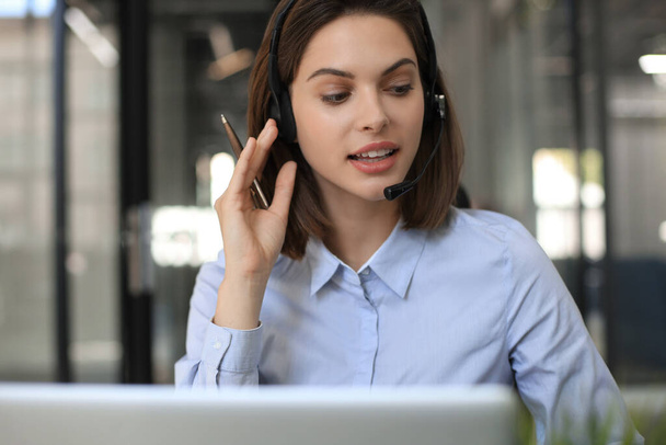 Female customer support operator with headset and smiling - Φωτογραφία, εικόνα