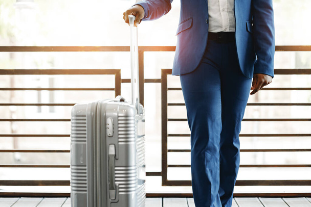 Unrecognizable businessman standing with luggage suitcase in hotel lobby - Valokuva, kuva