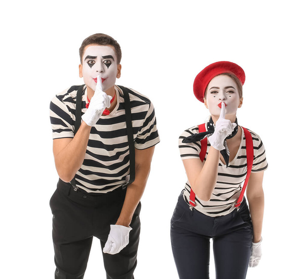 Male and female pantomimists showing silence gesture on white background - Photo, Image