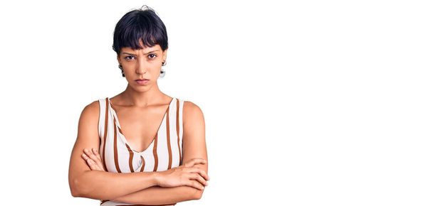 Young brunette woman with short hair wearing summer outfit skeptic and nervous, disapproving expression on face with crossed arms. negative person.  - Foto, Imagem