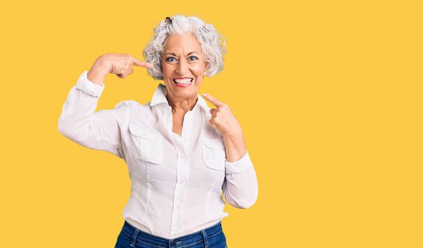Senior grey-haired woman wearing casual clothes smiling cheerful showing and pointing with fingers teeth and mouth. dental health concept.  - Zdjęcie, obraz