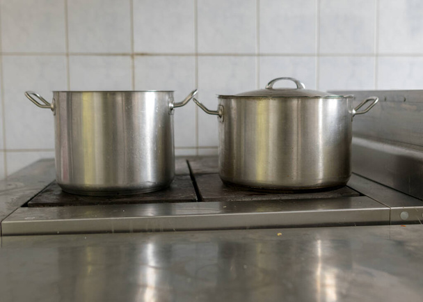 metal pot on the stove top, school kitchen, eat cooking concept - Фото, изображение