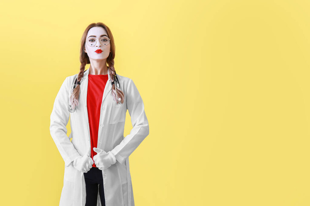 Female pantomimist dressed as doctor on color background - Photo, Image