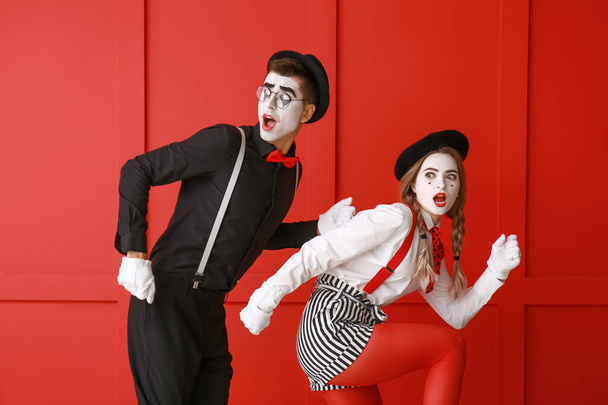 Male and female pantomimists on color background - Valokuva, kuva