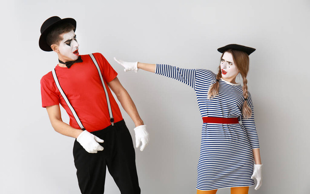 Male and female pantomimists on grey background - Photo, Image