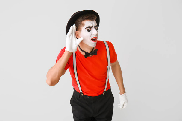 Male pantomimist on grey background - Photo, Image