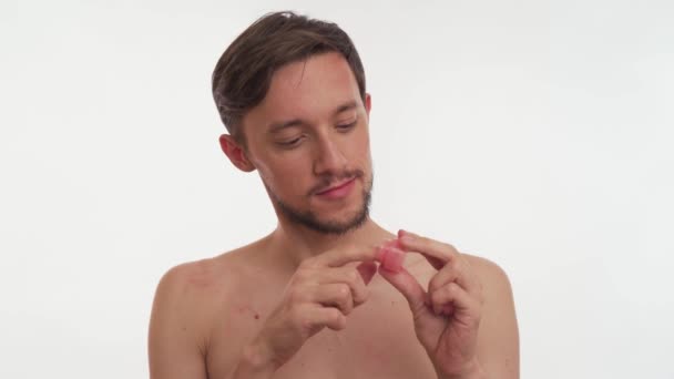 Close-up of one handsome man painting his lips with lip gloss. Concept of protecting rights of LGBT community, a clear manifestation of homosexuality and the manifestation of female qualities in men. - Footage, Video