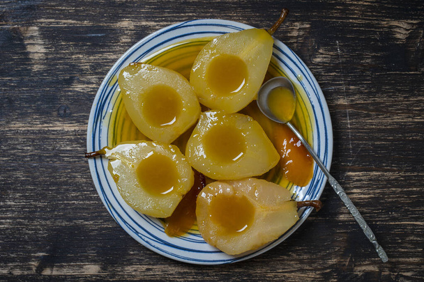 Baked pears in orange juice, close up, top view. Delicious dessert. - Photo, image