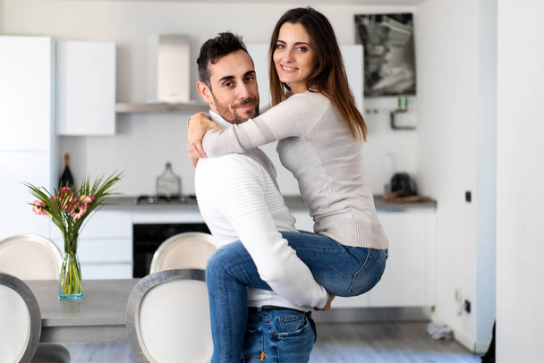 Glückliches Paar beim Umarmen im neuen Zuhause - Foto, Bild
