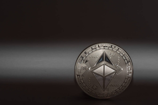 single ether coin from cryptocurrency with shadow on black background - Photo, Image