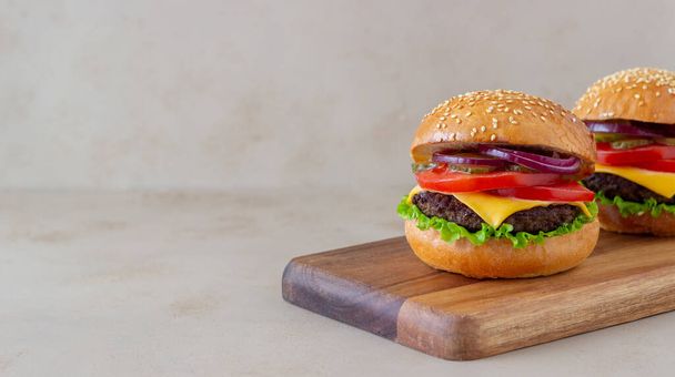 Burgers with cutlet, tomato, lettuce, cucumber, onion and cheese. American cuisine Fast food Cheeseburger - Φωτογραφία, εικόνα