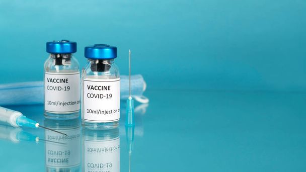 Coronavirus vaccine background. Covid-19 vaccination with vaccine bottle. Syringe injection tool for corona immunization treatment. Vaccine against the pandemic. Copy space. - Photo, image