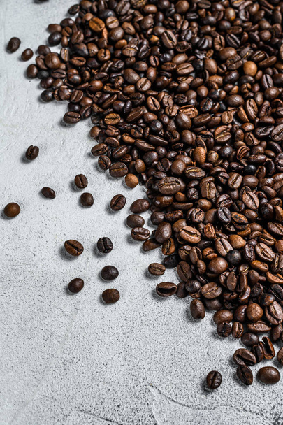 Roasted coffee beans on rustic table. White background. Top view. Copy space - Photo, Image