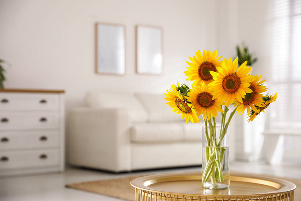 Beautiful bouquet of sunflowers in vase on table indoors. Space for text - Foto, immagini