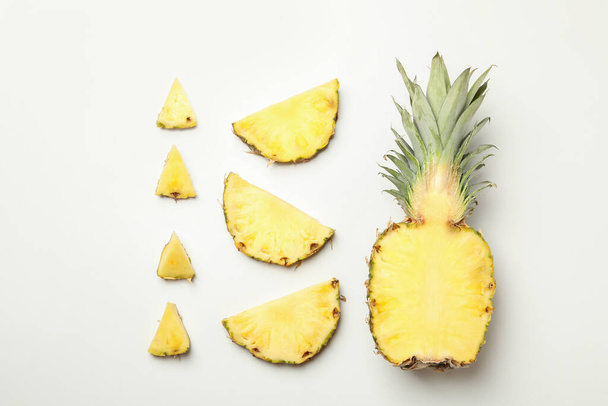 Flat lay with pineapple and slices on white background - Photo, Image