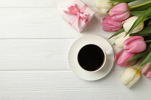 Tulips, coffee and gift box on white wooden background, space for text - 写真・画像