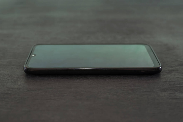 black smartphone on a black background. - Photo, Image