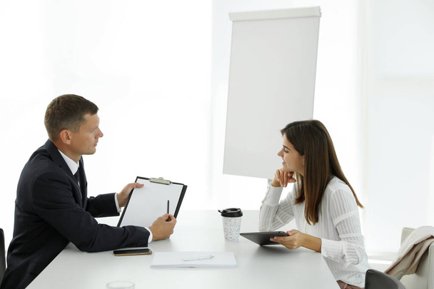 Office employees talking at table during meeting - Φωτογραφία, εικόνα
