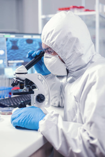 Researcher in modern microbiology laboratory uses microscope - Zdjęcie, obraz