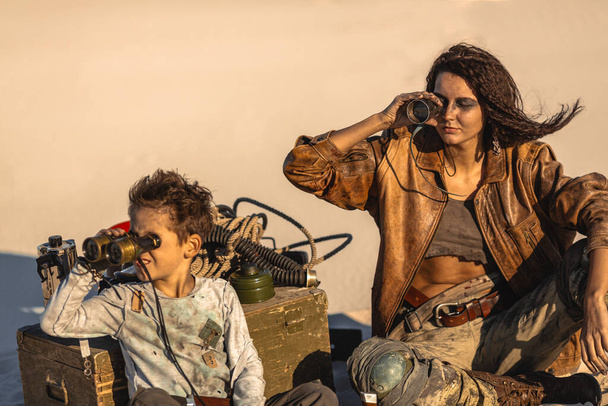 Post apocalyptic Woman and Boy Outdoors in a Wasteland - Photo, Image
