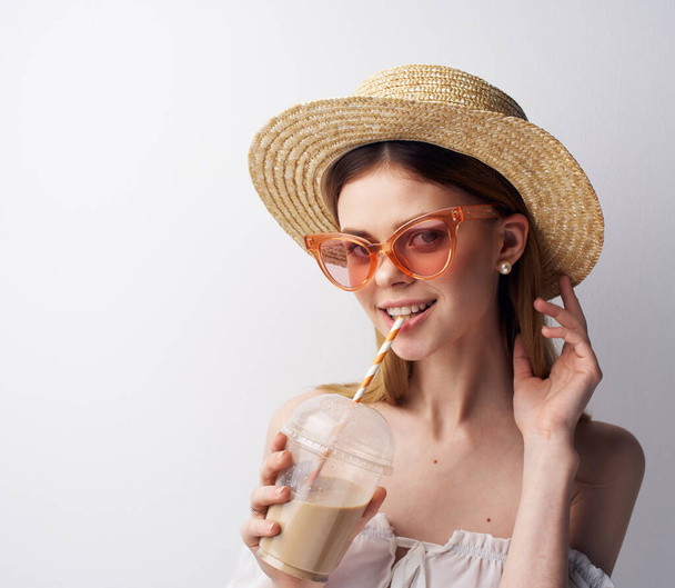 Cheerful woman in pink glasses hat glass with drink fun model - Photo, image