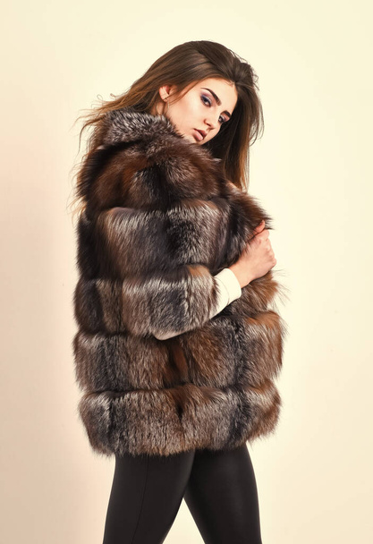 Woman makeup and hairstyle posing mink or sable fur coat. Fur fashion concept. Winter elite luxury clothes. Female brown fur coat. Fur store model enjoy warm in soft fluffy coat with collar - Foto, Imagem
