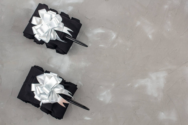 Serbatoi fatti a mano di calzini come regalo per gli uomini il 23 febbraio su sfondo grigio con copyspace - Foto, immagini