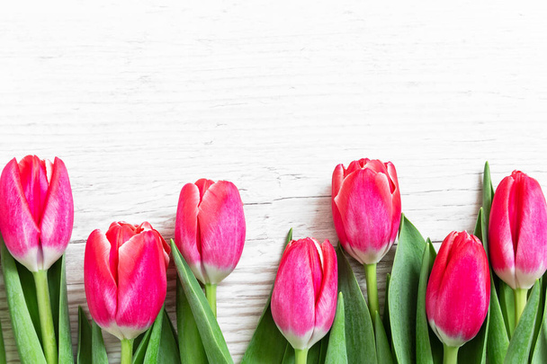 Beautiful pink tulips on wooden background. Greeting card with tulips for Mothers day or Easter. Spring concept. - Valokuva, kuva