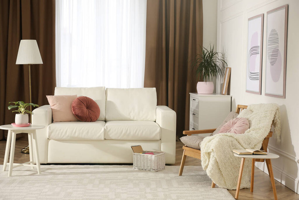 Stylish living room interior with comfortable sofa and armchair - Фото, изображение