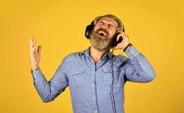 Music beat. Noise cancellation function. Man bearded hipster headphones listening music. Dj hipster. Excellent music playlist. Hipster enjoy excellent sound song in earphones. Rhythm concept - Photo, image