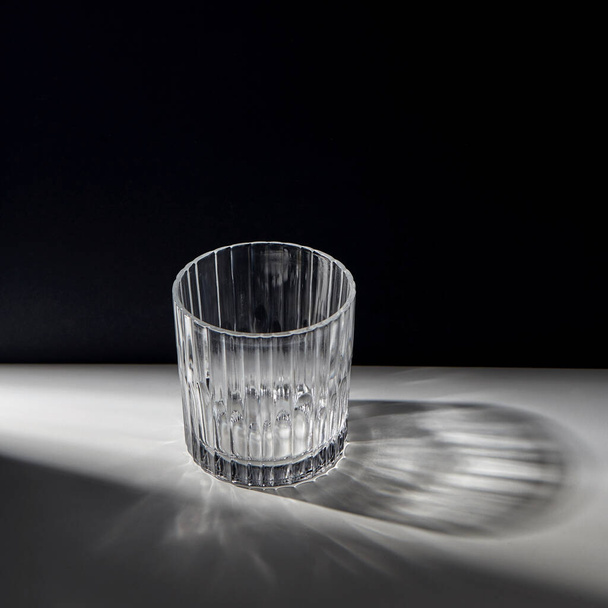 empty faceted glass on table - Fotoğraf, Görsel