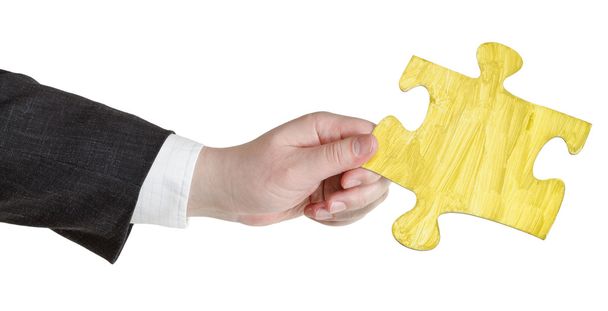 main masculine avec pièce de puzzle jaune peint
 - Photo, image