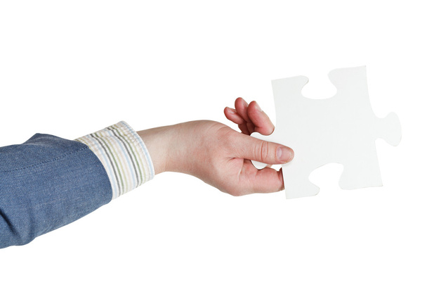 male hand holding big white paper puzzle piece - Photo, Image