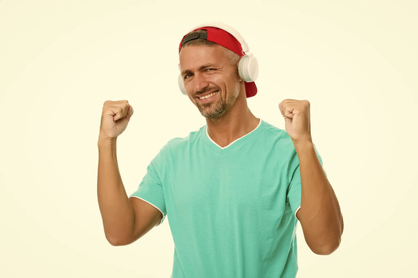 Perfect sound concept. Electronic dance music and house tracks. Guy in cap listen music stereo headphones. Instrumental music. Man headphones white background. Good mood. Modern wireless headphones - Photo, Image