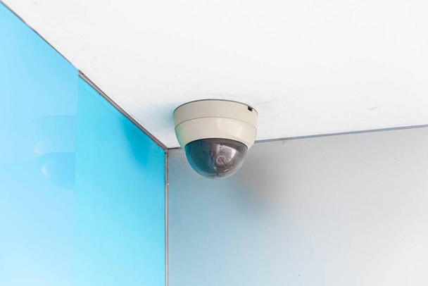 Round cctv camera mounted on the ceiling at the bank  - Foto, immagini