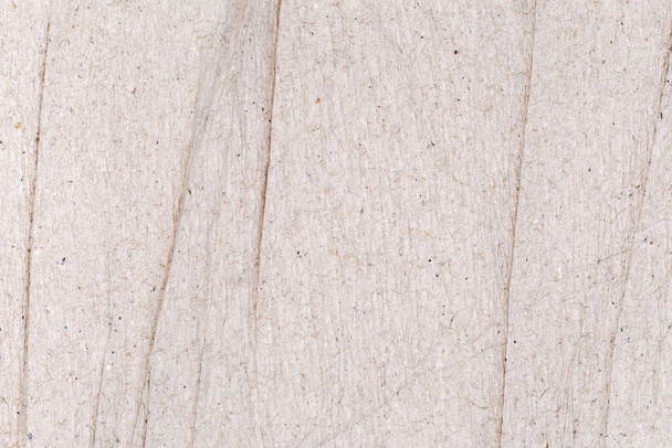 Fragmento de hoja de marrón gris ligeramente arrugado sin blanquear papel crepé suave primer plano, textura, fondo - Foto, imagen